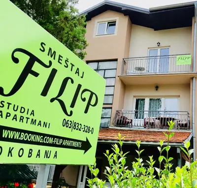 a real estate sign in front of a house at Filip Apartments in Soko Banja