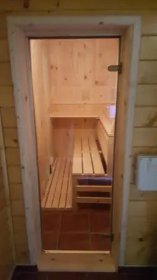 a small room in a wooden cabin with a small door at Holiday Home Floris in Kopaonik