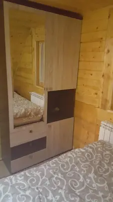 a bedroom with a bed in a wooden room at Holiday Home Floris in Kopaonik