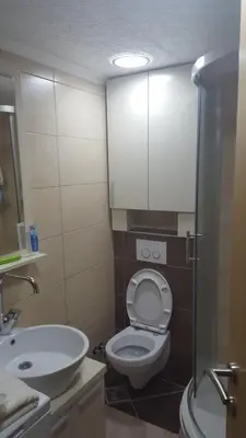 a bathroom with a toilet and a sink and a shower at Holiday Home Floris in Kopaonik