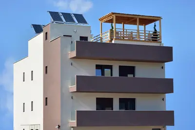 a building with solar panels on top of it at Lotos Depandans in Niš