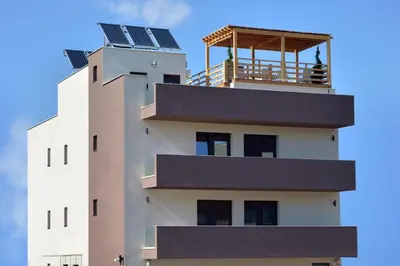 a building with solar panels on top of it at Lotos Depandans in Niš