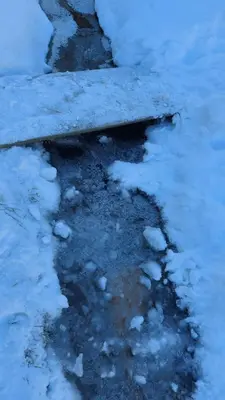 a puddle of snow on a sidewalk with snow at Marko'S Apartments in Kopaonik