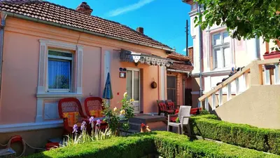 a house with chairs and a porch with a window at Vila Milenovic Rajacke Pivnice in Rajac
