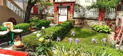 a miniature garden with figurines of people in a yard at Vila Milenovic Rajacke Pivnice in Rajac