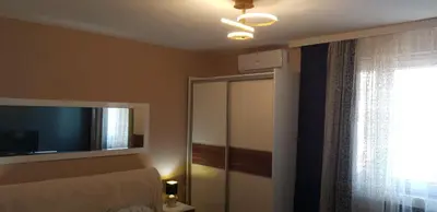 a bedroom with a bed and a tv and a window at Apartman Sweet dreams 1 in Niš