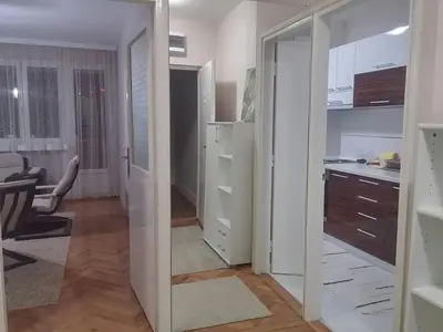 a room with a kitchen and a hallway with a mirror at Apartman Sweet dreams 1 in Niš