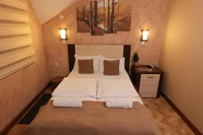 a bedroom with a large bed in a room at Cuki Residence in Mala Ravna Reka