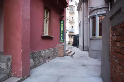 a red building with a sign on the side of it at Sweet Apartments or Rooms in Niš