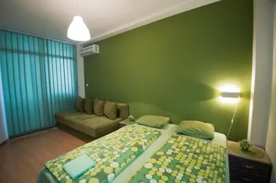 a living room with two beds and a couch at Sweet Apartments or Rooms in Niš