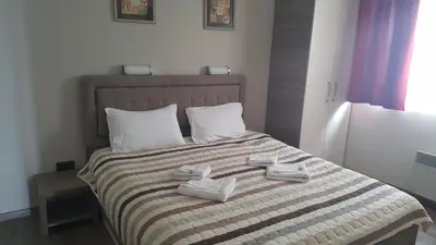 a bedroom with a bed with white shoes on it at Apartment Andrijana in Kopaonik