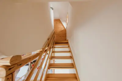a staircase in a house with wooden floors at Holiday Home Elena in Kopaonik