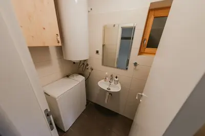 a small bathroom with a toilet and a sink at Holiday Home Elena in Kopaonik