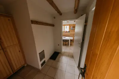 a hallway with a door to a room with a kitchen at Holiday Home Elena in Kopaonik