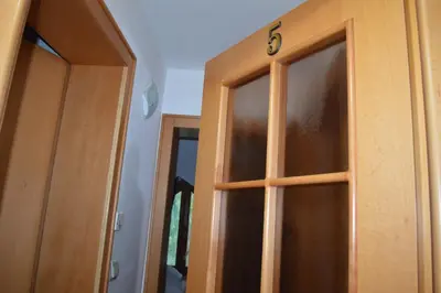 a pair of wooden doors in a room at Guest House Vila Horizont in Goč