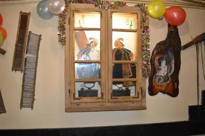 a window with decorations on a wall with balloons at Guest House Vila Horizont in Goč