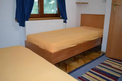 a bedroom with two beds and a window at Guest House Vila Horizont in Goč