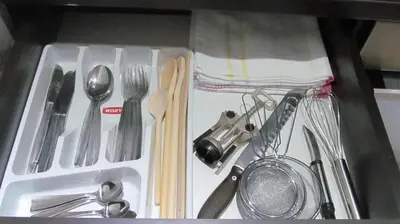 a white tray with utensils in a drawer at Apartments Vanja i Vrh in Kopaonik