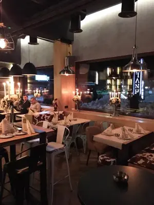 a restaurant with tables and chairs and a bar at Apartments KOP Konaci in Kopaonik