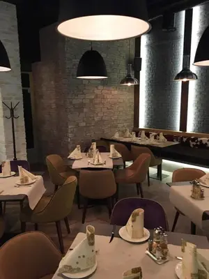 a dining room with tables and chairs and lights at Apartments KOP Konaci in Kopaonik