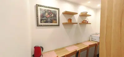 a dining room with a table and a picture on the wall at Apartments KOP Konaci in Kopaonik