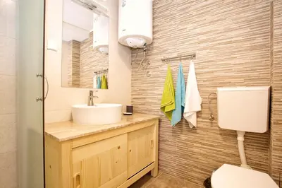 a bathroom with a sink and a toilet at Alpine Retreat Čupino Sokače in Kopaonik