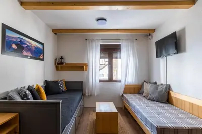 a living room with a couch and a table at Alpine Retreat Čupino Sokače in Kopaonik