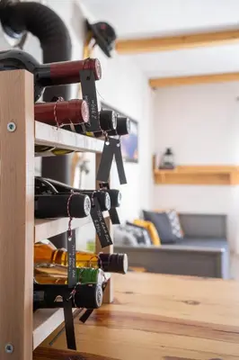 a bunch of wine bottles on a shelf in a room at Alpine Retreat Čupino Sokače in Kopaonik