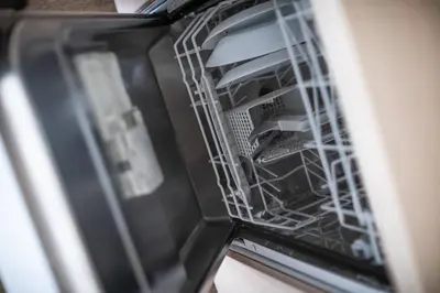 a dishwasher with its door open with dishes in it at Alpine Retreat Čupino Sokače in Kopaonik