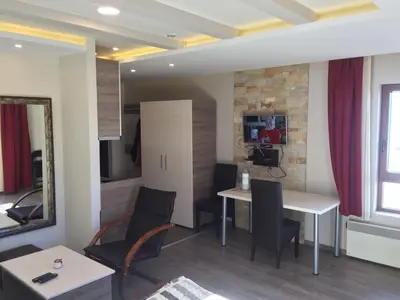 a living room with a table and chairs at Panorama apartments in Milmari Resort in Kopaonik