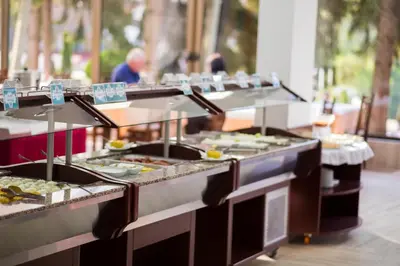 a buffet line with many different types of food at Hotel Radan Prolom Banja in Prolomska Banja