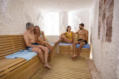 a group of people sitting on a bench in a room at Hotel Radan Prolom Banja in Prolomska Banja