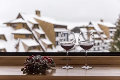 two glasses of wine sitting on a window sill at Apartments Mozaik in Kopaonik