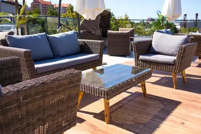 a group of chairs and tables on a patio at Apel Luxury in Niš