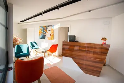 a living room with chairs and a table at Apel Luxury in Niš