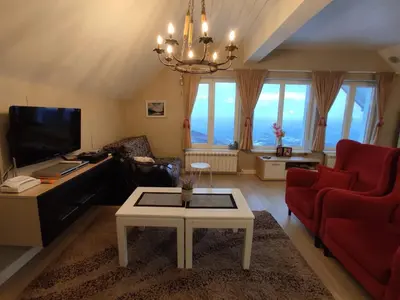 a living room with a couch and a table at Apartment Jelena in Kopaonik
