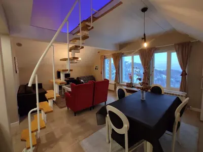 a living room with a black table and chairs at Apartment Jelena in Kopaonik