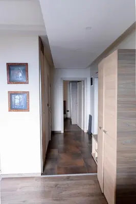 a hallway of an apartment with wood floors and white walls at Apartment G6 in Kopaonik