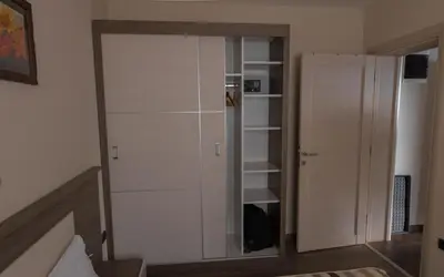a room with a book shelf and a closet at Apartment G6 in Kopaonik