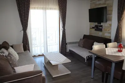 a living room with a couch and a table at Apartment G6 in Kopaonik