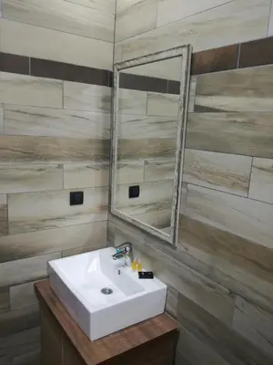 a bathroom with a sink and a mirror at Apartment G6 in Kopaonik
