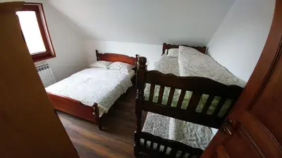 two twin beds in a room with a window at Vila Tisa in Kopaonik