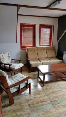 a living room with a couch and a coffee table at Vila Tisa in Kopaonik