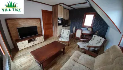 a living room with a couch and a tv at Vila Tisa in Kopaonik