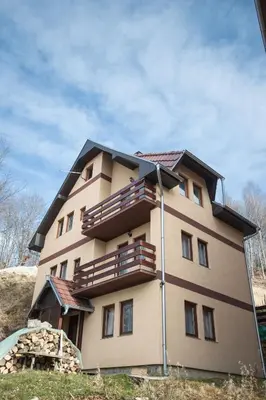 a building with a balcony on the side of it at Vila Tisa in Kopaonik