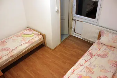 a small room with two beds and a window at Stara Planina Vila Vesela kuca in Jalovik Izvor