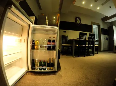 an open refrigerator filled with lots of bottles of alcohol at SM Apartments Kopaonik in Kopaonik