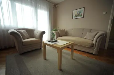 a living room with a couch and a table and a chair at Apartman Rada in Pirot