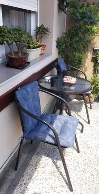 a table and chairs sitting on a balcony with a table and a table at Apartman Rada in Pirot