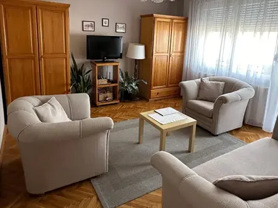 a living room with two chairs and a tv at Apartman Rada in Pirot